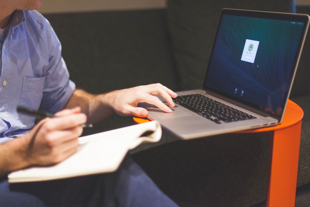 Person Working On Laptop With Macbook